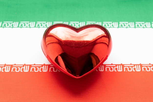 Photo red heart is on the flag of iran the concept of patriotic feelings for one's state patriotism