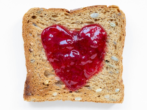 red heart jam on fried toast isolated on white