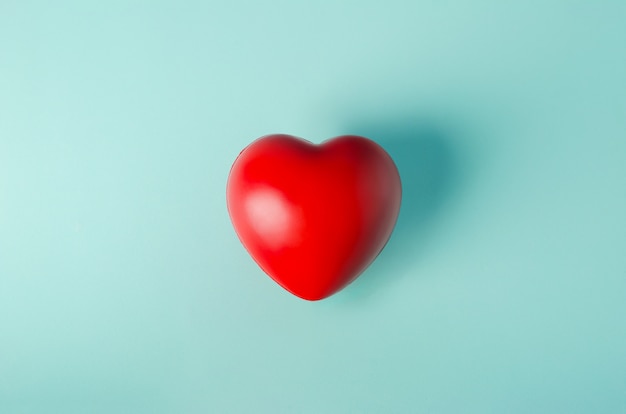 Red heart on light blue green background