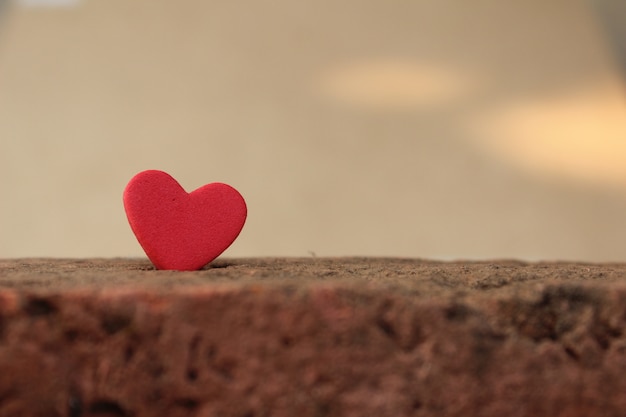 Red heart on old bricks