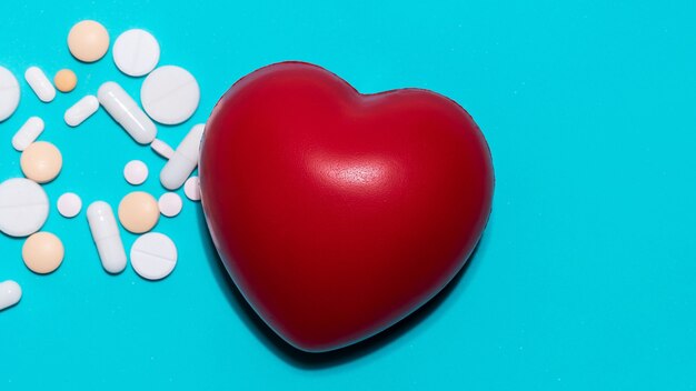 Red heart and pills on a blue background