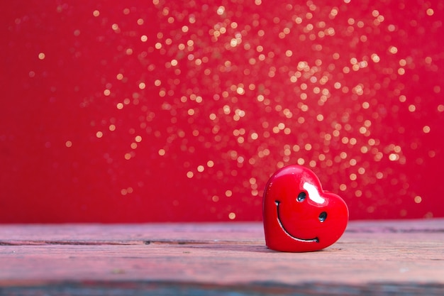 red heart on a red shiny background, copy space