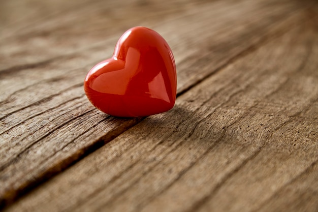 Red heart on the rustic vintage wooden table