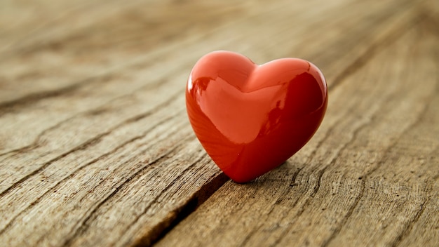 Red heart on the rustic vintage wooden table