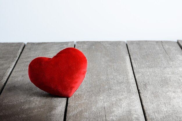 Red Heart Shape pillows on wooden background