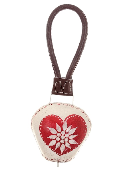 A red heart shaped pendant with a flower on it.