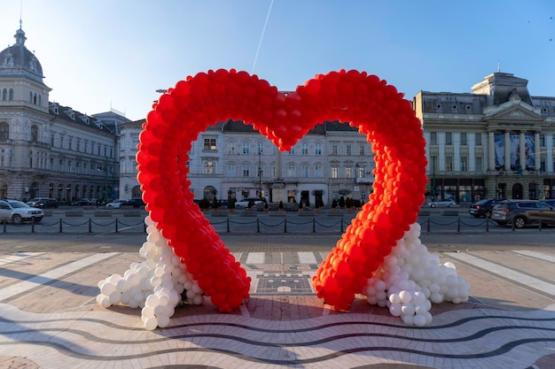 A red heart shaped sculpture with the word love on it