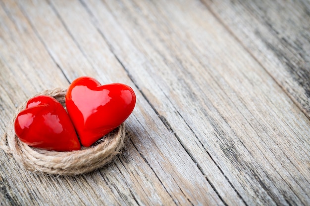 Red heart-shaped on a wooden background.