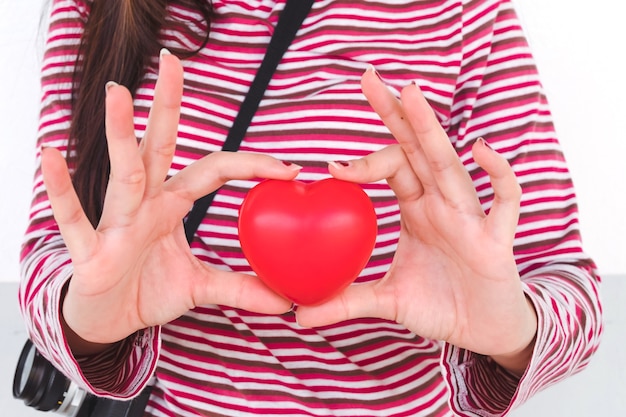 red heart sign in young girl hand.