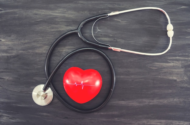 red heart and stethoscope on a black background