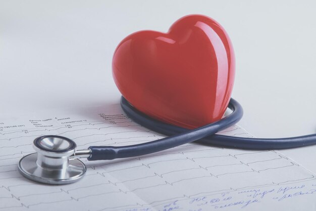 Red heart and a stethoscope on desk