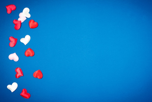 Red heart for Valentine's Day on a beautiful blue background. Heart pendant. 