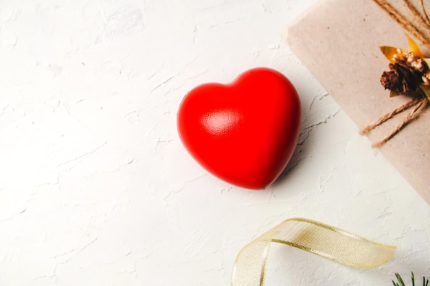 Red heart on white cement background