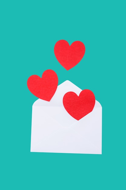 Red heart in a white envelope on a blue background