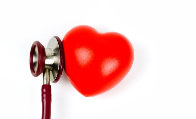 Red heart with stethoscope on white background Selective focus. Health care concept