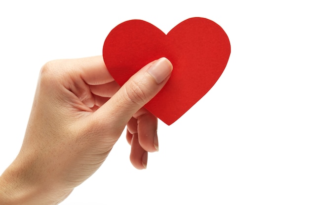 Red heart in woman hand on white