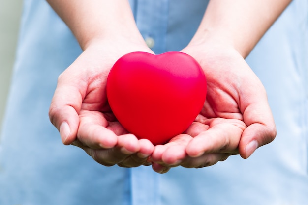 The red heart on woman hand