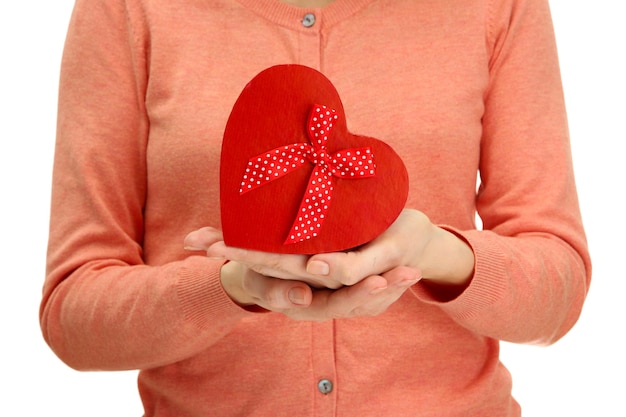 Red heart in woman hands, close up