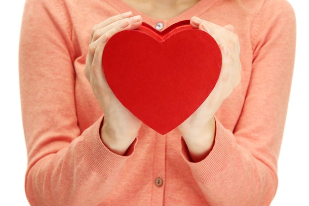 Red heart in woman hands, close up