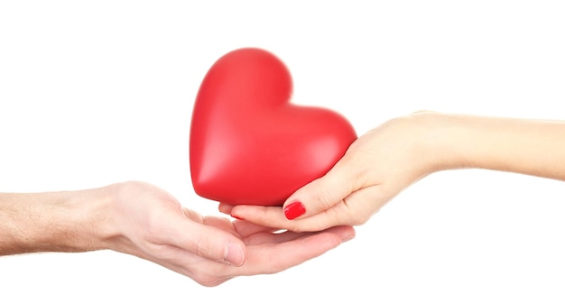 Red heart in woman and man hands, isolated on white