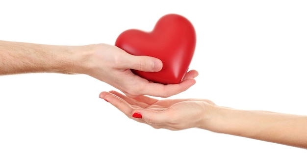 Red heart in woman and man hands, isolated on white