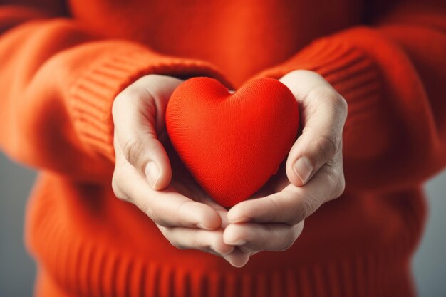 Red heart in womens hand