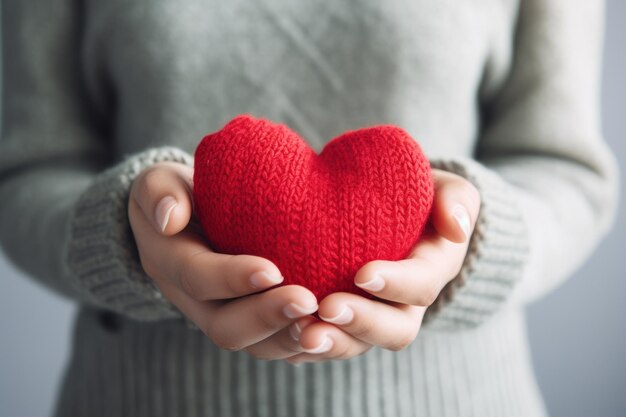 Red heart in womens hand