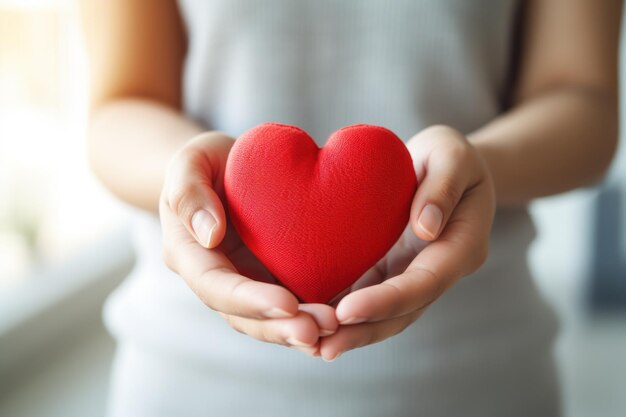 Red heart in womens hand