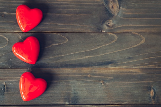 Red heart on wood table background with copy space 