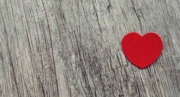 Red heart on wooden background vintage style