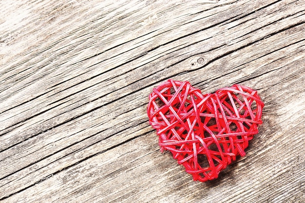 Red heart on wooden background