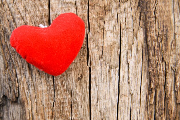 Red heart on the wooden background