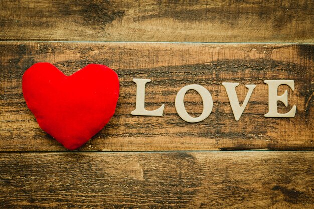 Red heart on a wooden background