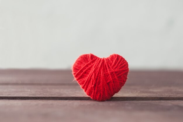 Red heart of wool thread. Valentine's day concept.