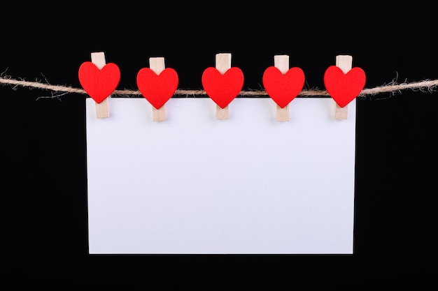 red hearts clothespin on rope