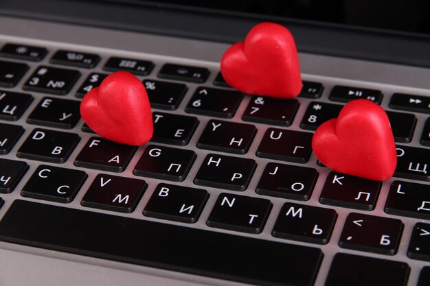 Red hearts on computer keyboard close up