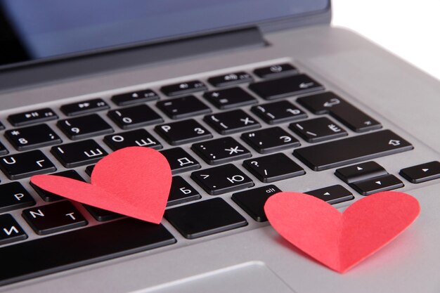 Red hearts on computer keyboard close up