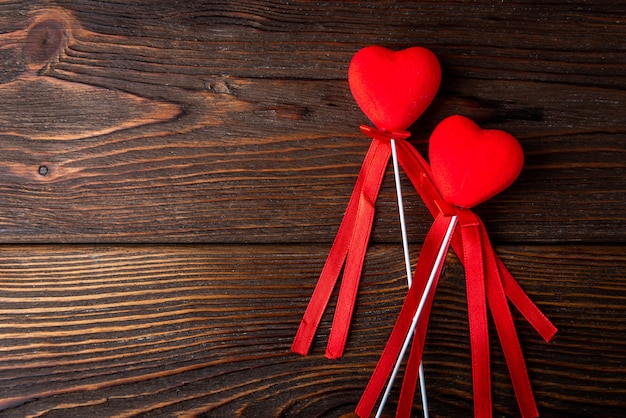 Red hearts on dark wooden