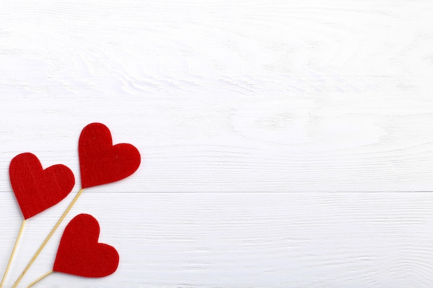 Red hearts of different sizes on a white background