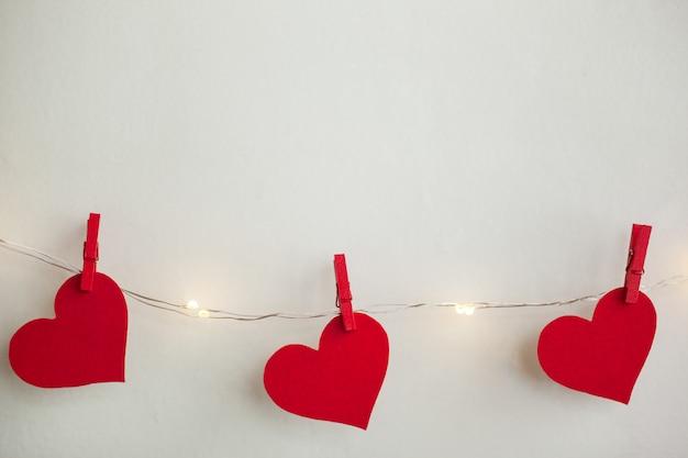 Red hearts hanging on the garland