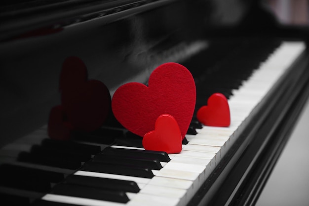 Red hearts on piano keys close up