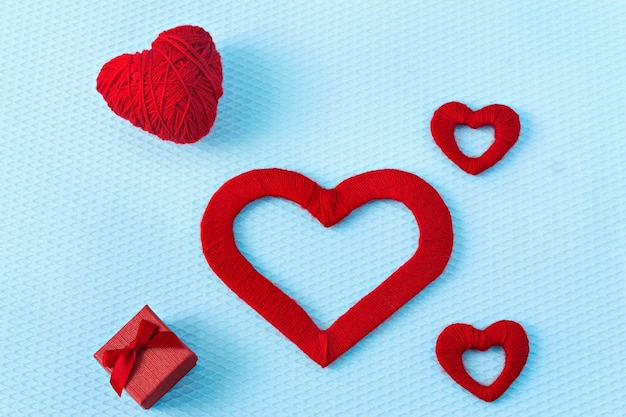 Red hearts and ring on a blue background