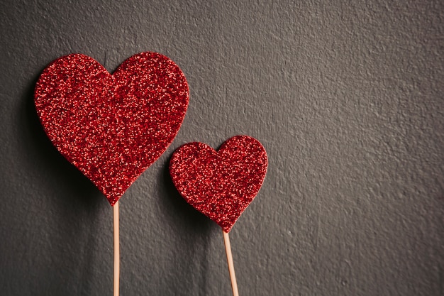 Red hearts shape isolated on grey background with copy space