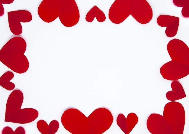 Photo red hearts shape paper cut pattern on the white background