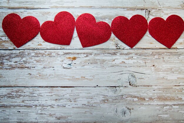 red hearts on wooden background