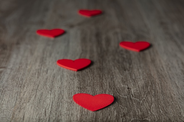 Red hearts on wooden table