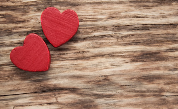 Red hearts on wooden table