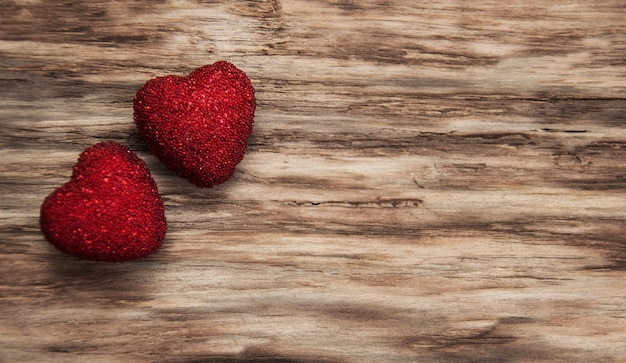 Red hearts on wooden table