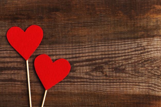 Red hearts on a wooden table. 