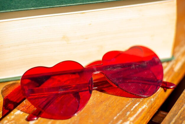 Red heartshaped glasses on a book